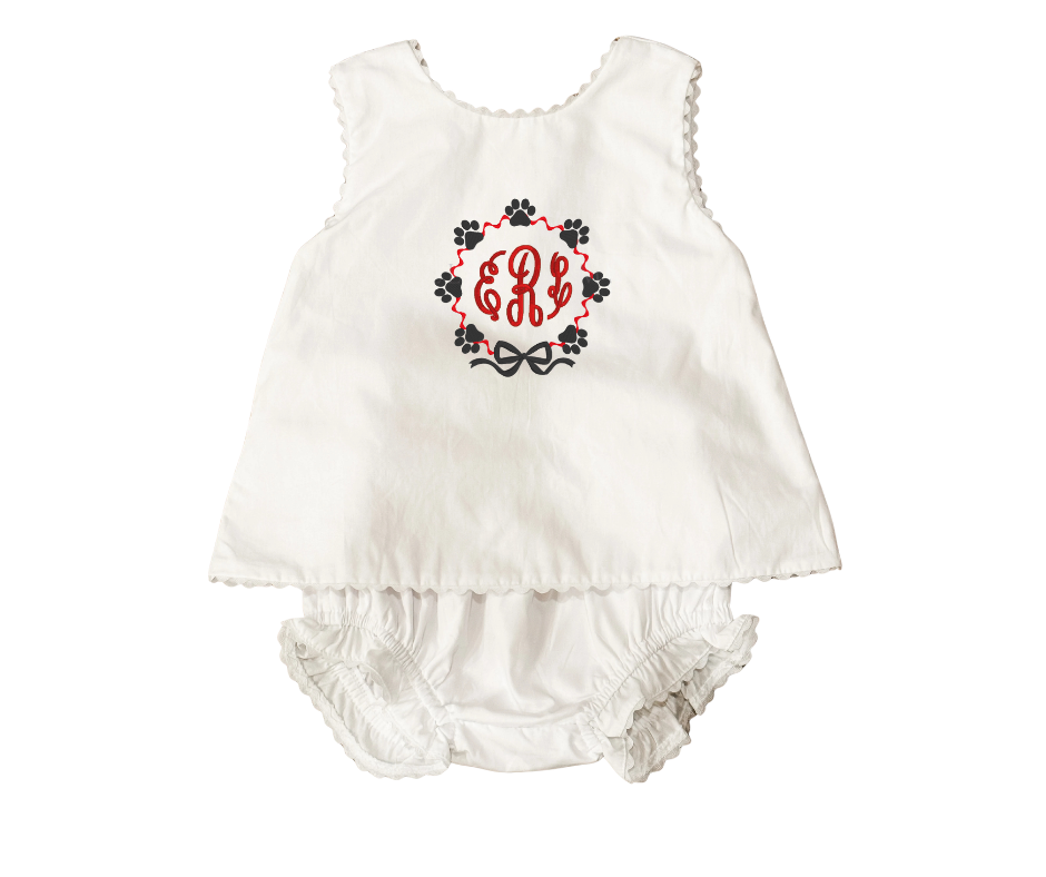 White baby romper with floral design and monogram on a white background