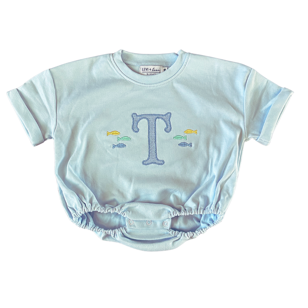 Light blue baby romper with letter 'T' and fish design on a white background